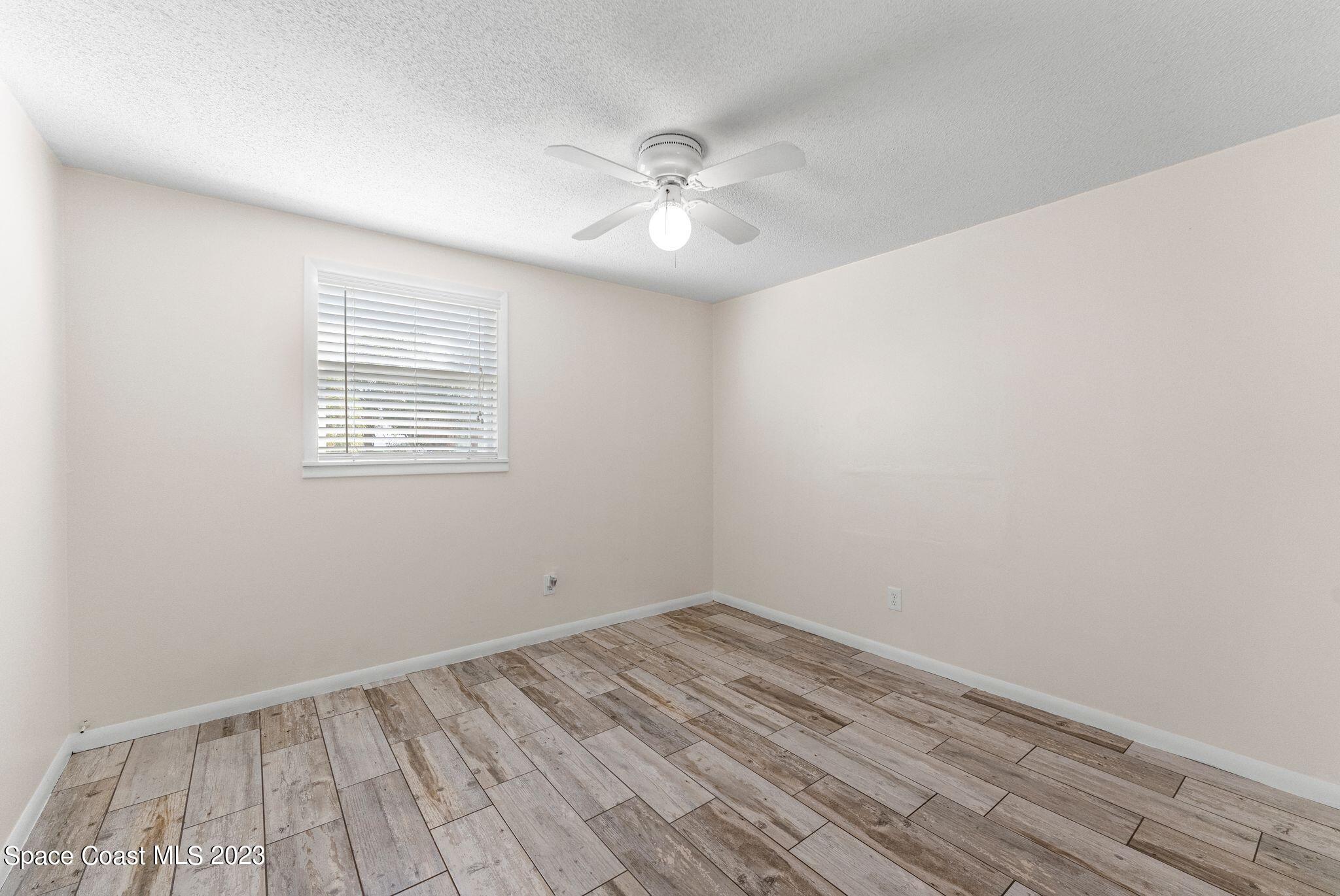 2007 Oak Street Melbourne Beach, FL 32951 - Photo 14 of 26 an empty room with a window and ceiling fan
