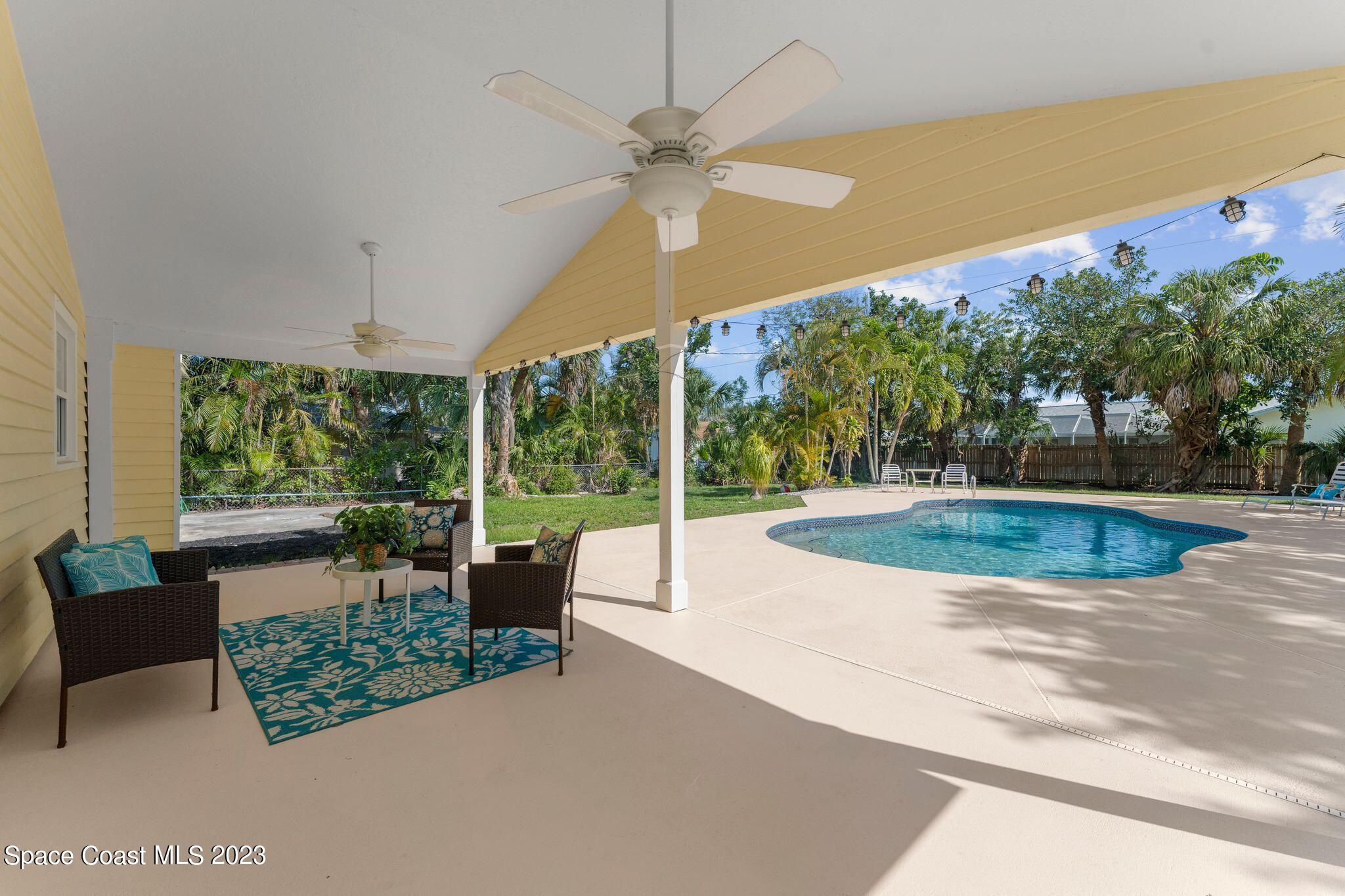 2007 Oak Street Melbourne Beach, FL 32951 - Photo 16 of 26 a view of a swimming pool with a couches in a patio