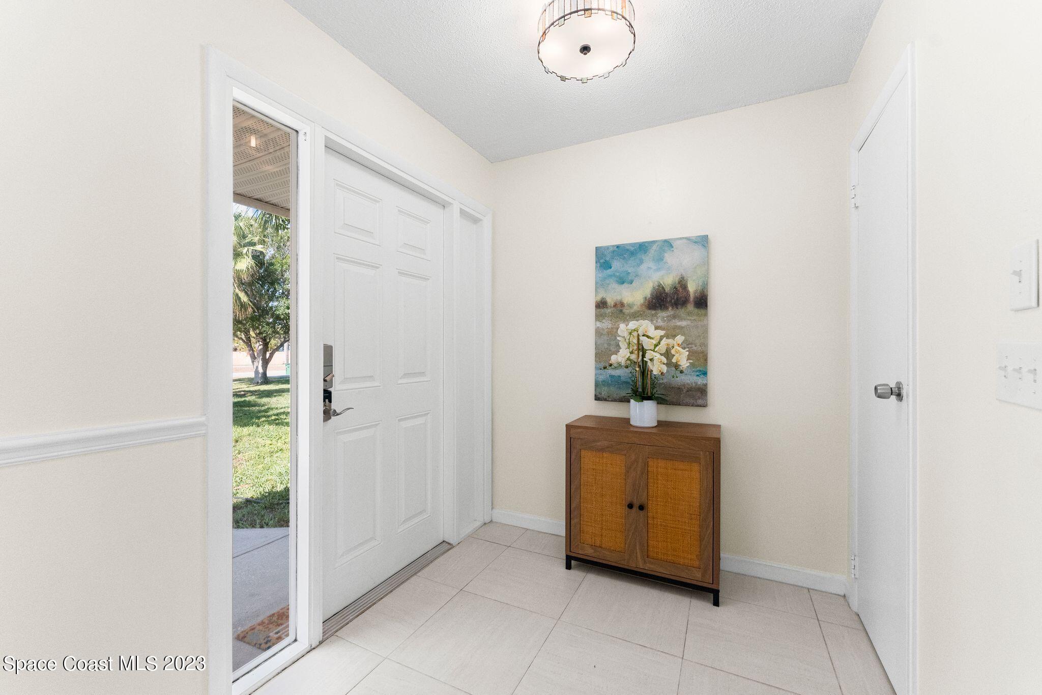 2007 Oak Street Melbourne Beach, FL 32951 - Photo 3 of 26 a room with a door and a window