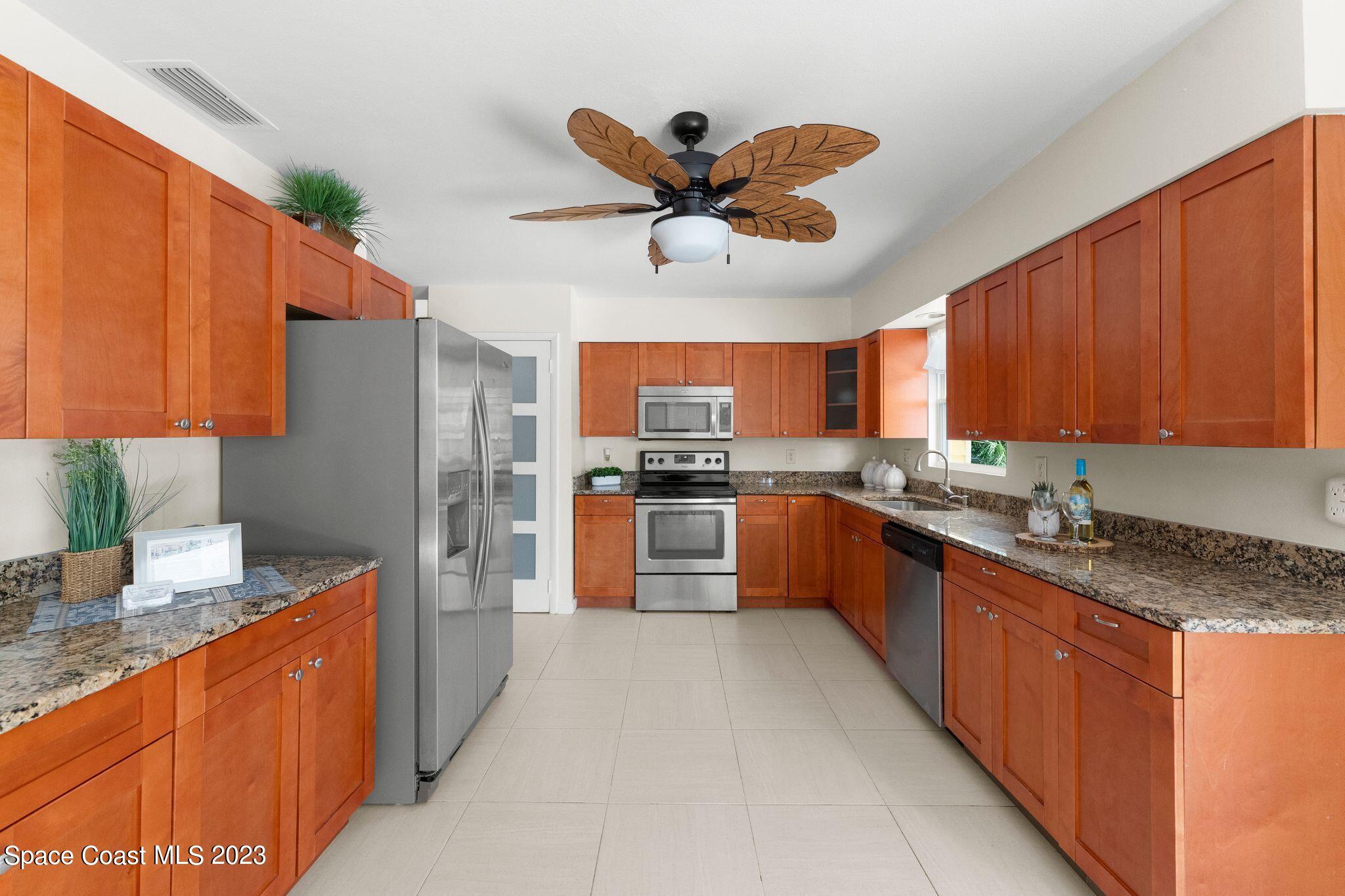 2007 Oak Street Melbourne Beach, FL 32951 - Photo 7 of 26 a large kitchen with stainless steel appliances granite countertop a sink counter space cabinets and a counter top space