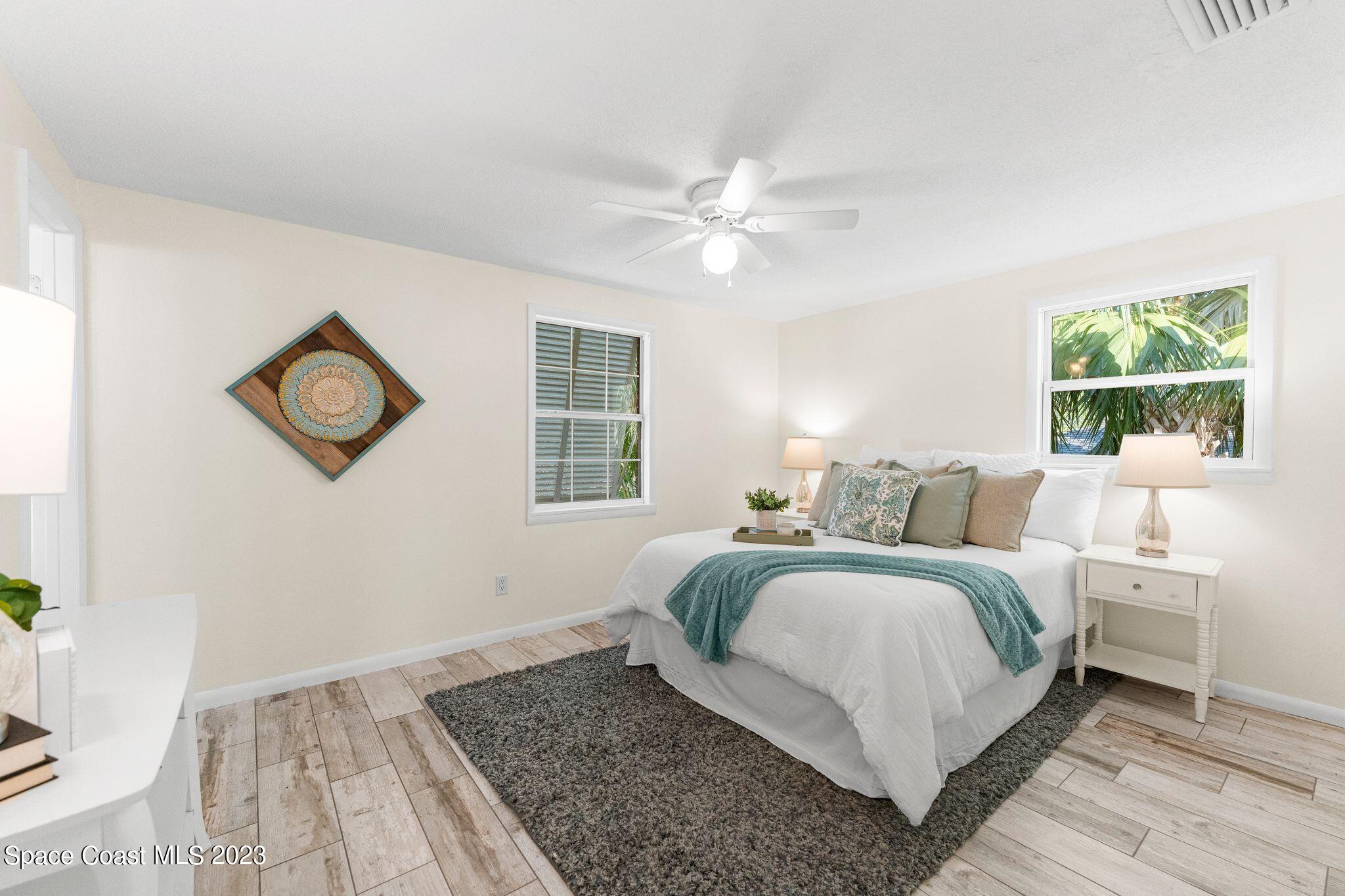 2007 Oak Street Melbourne Beach, FL 32951 - Photo 9 of 26 a bedroom with a large bed and a window