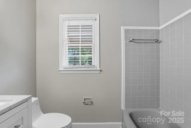 a bathroom with a toilet a sink and a shower