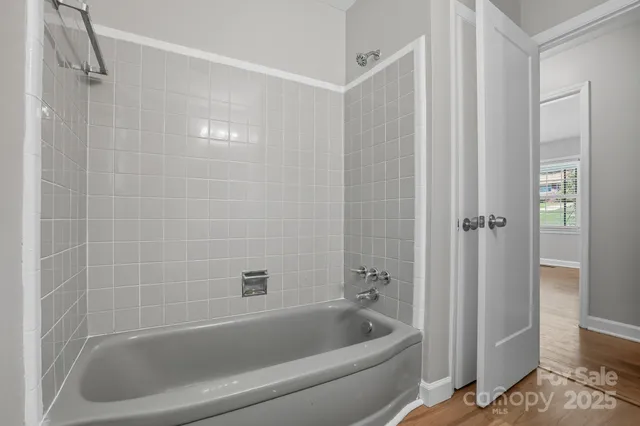 a bathroom with a bathtub and shower