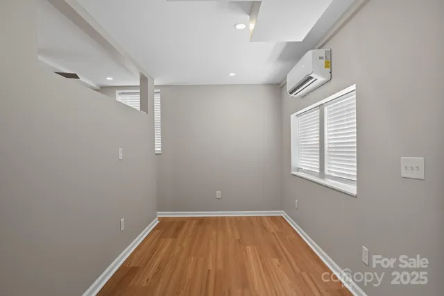 a view of a room with wooden floor and windows