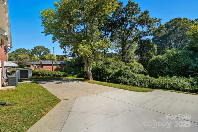 a view of a patio with a table and chairs under an umbrella
