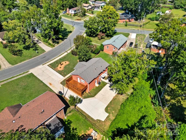 an aerial view of a house with a yard and garden