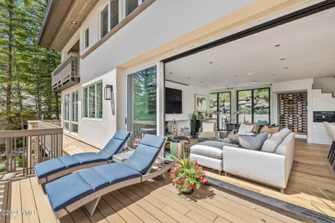 a view of a balcony with furniture and wooden floor