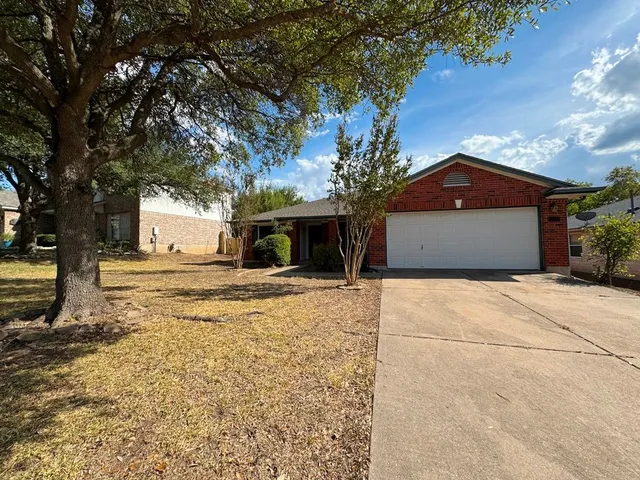 a front view of a house with a yard and a garage