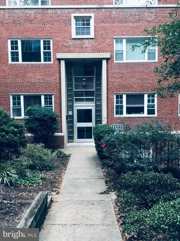 a front view of a house with garden and porch