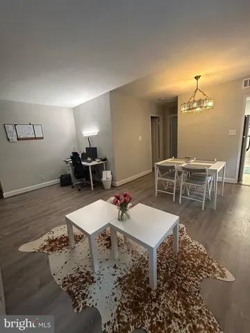 a living room with dining room and wooden floor