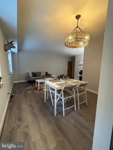 a view of a dining room with furniture wooden floor and chandelier