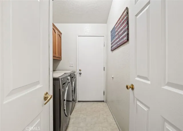 a view of a storage & utility room with a washer dryer