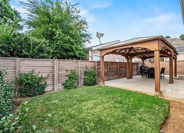 a view of a house with a small yard and plants