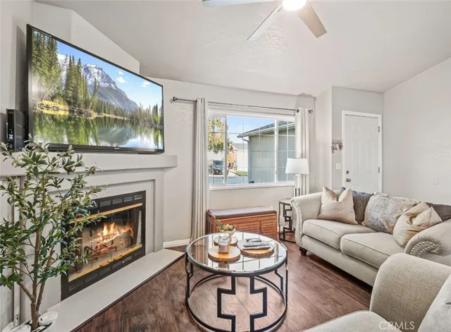 a living room with furniture a fireplace and a large window