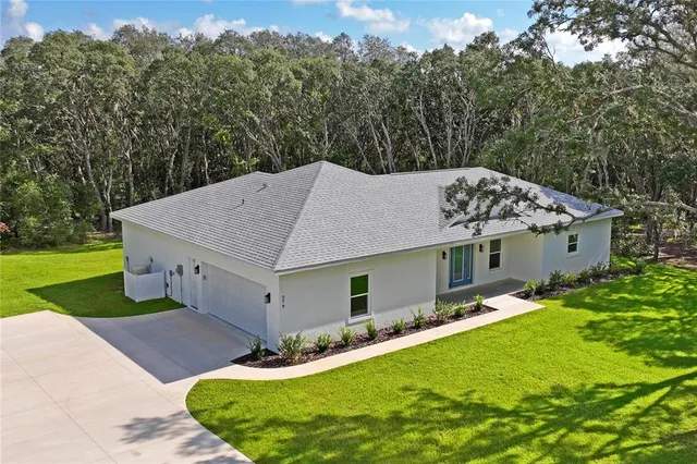 an aerial view of a house with a yard