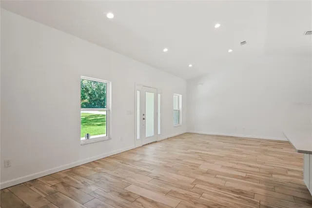 a view of a kitchen with stove and cabinets