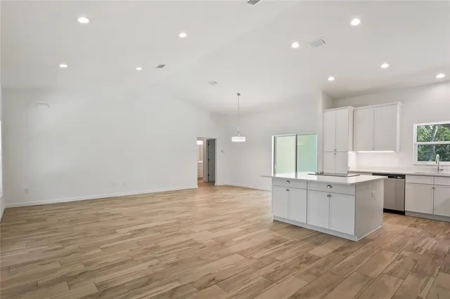 a kitchen with stainless steel appliances a sink a stove a refrigerator and cabinets
