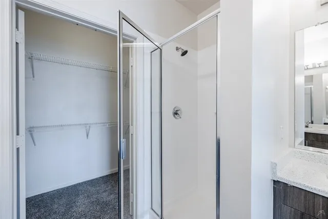 a bathroom with a glass door shower