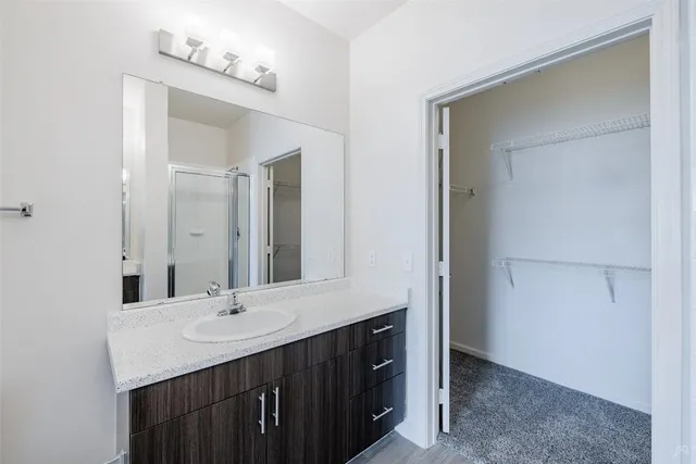 a bathroom with a double vanity sink and a mirror