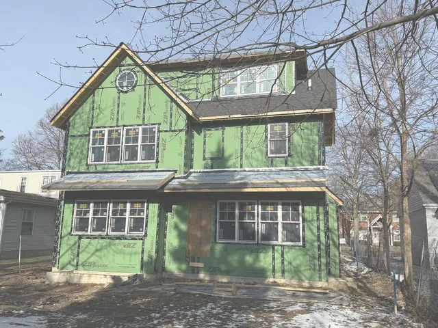 a front view of house with a garden