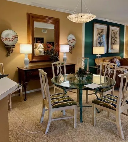 a dining room with furniture and a floor to ceiling window