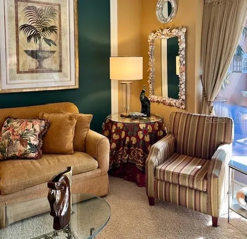 a living room with furniture a window and a book shelf