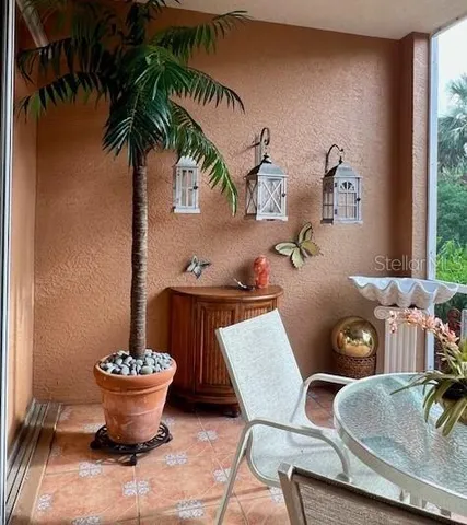 a bedroom with a bed lamp and a large window