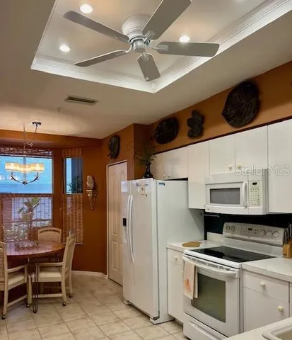 a kitchen with a sink a stove and cabinets