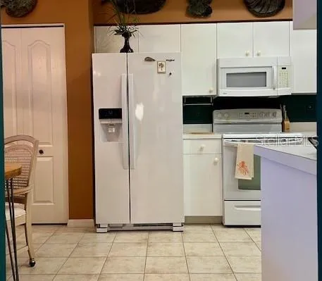 a kitchen with stainless steel appliances a refrigerator a sink and cabinets