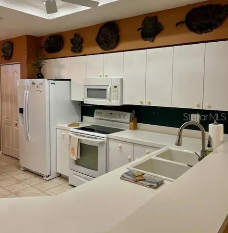 a kitchen with stainless steel appliances granite countertop a sink and cabinets
