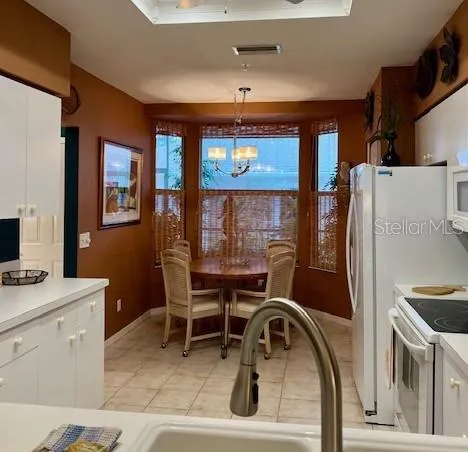 a hallway with painting on the wall and a potted plant