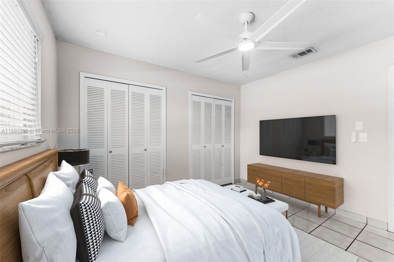 10121 Southwest 4th Street Miami, FL 33174 - Photo 17 of 31 a bedroom with a bed and a flat screen tv