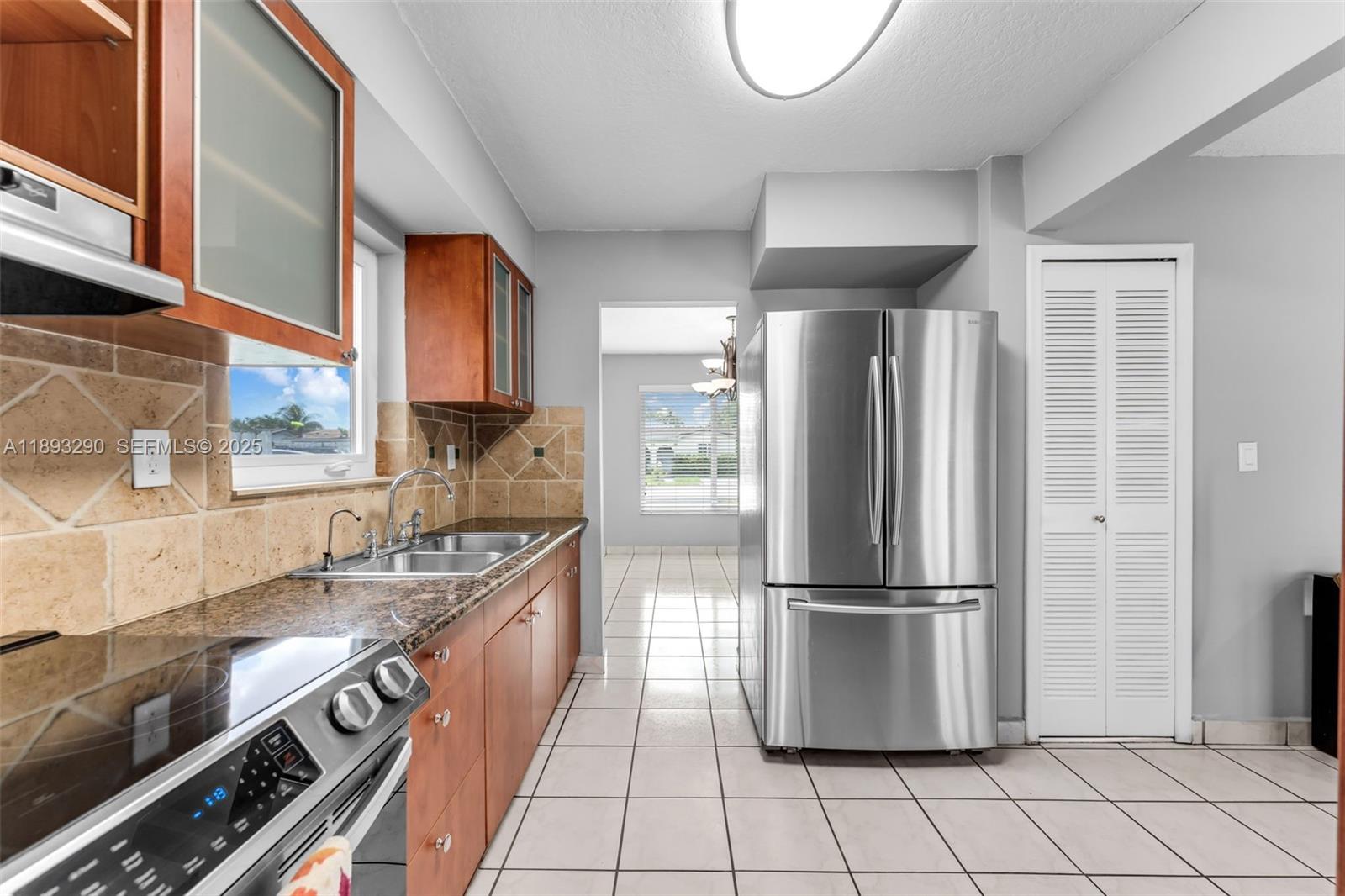 10121 Southwest 4th Street Miami, FL 33174 - Photo 10 of 31 a kitchen with stainless steel appliances granite countertop a refrigerator a sink and a stove