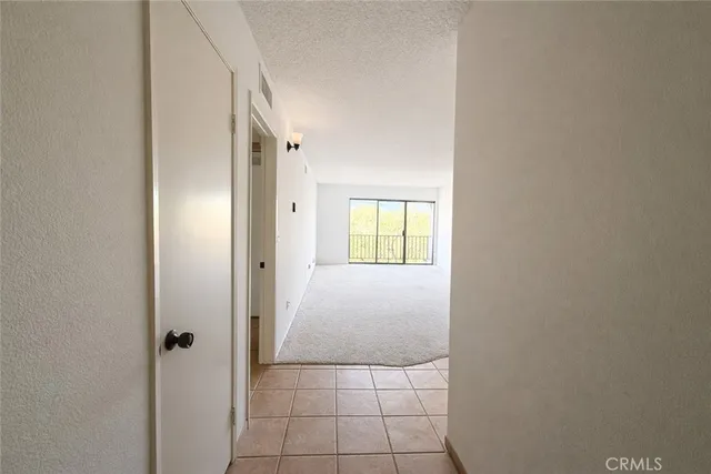 a view of a livingroom with a ceiling fan and window
