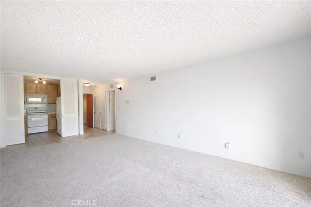 a kitchen with a sink cabinets and a wooden floor
