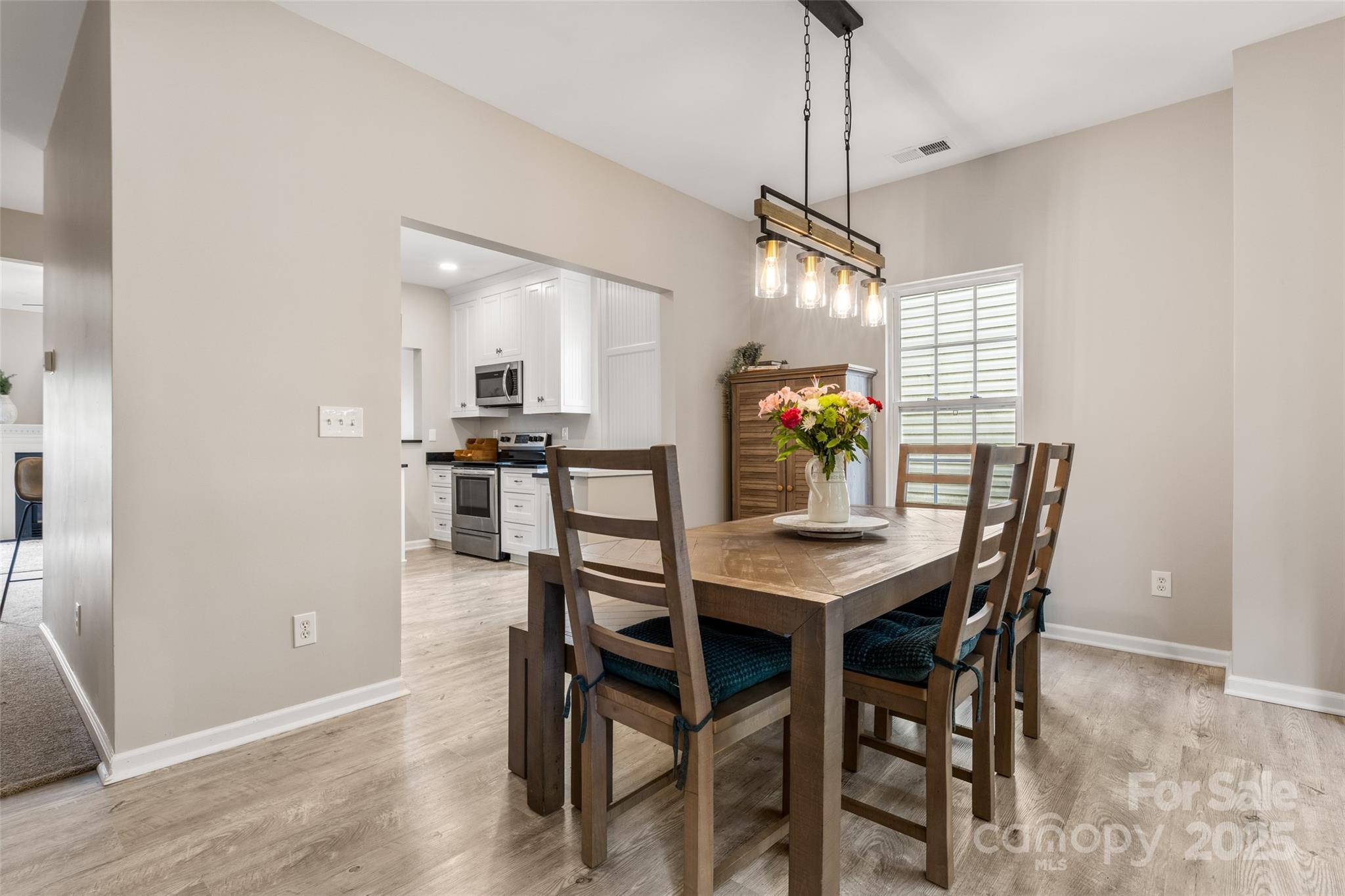 9651 Bailey Road Cornelius, NC 28031 - Photo 13 of 32 a view of a dining room with furniture and wooden floor