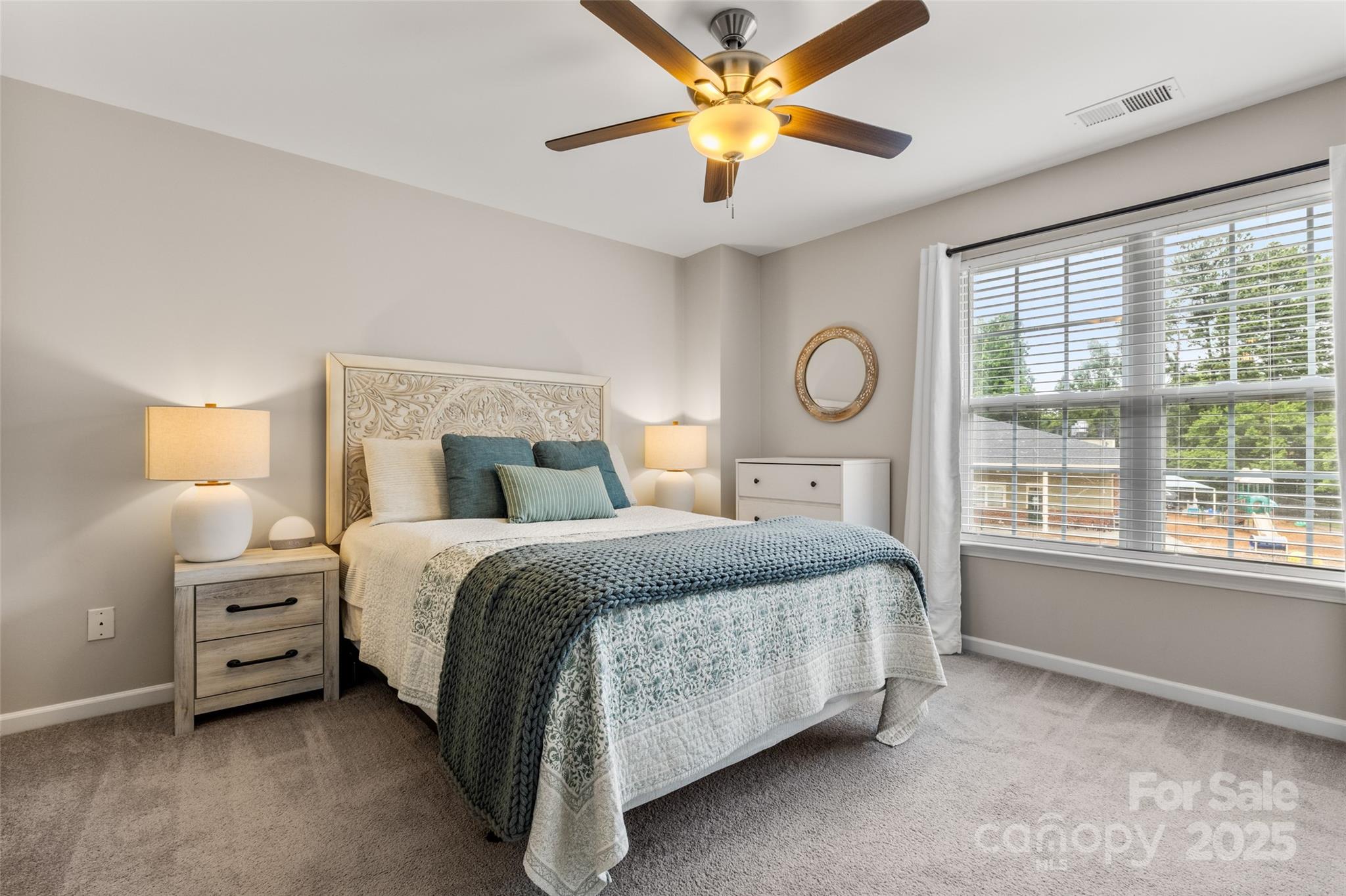 9651 Bailey Road Cornelius, NC 28031 - Photo 19 of 32 a bedroom with a bed chandelier and a window