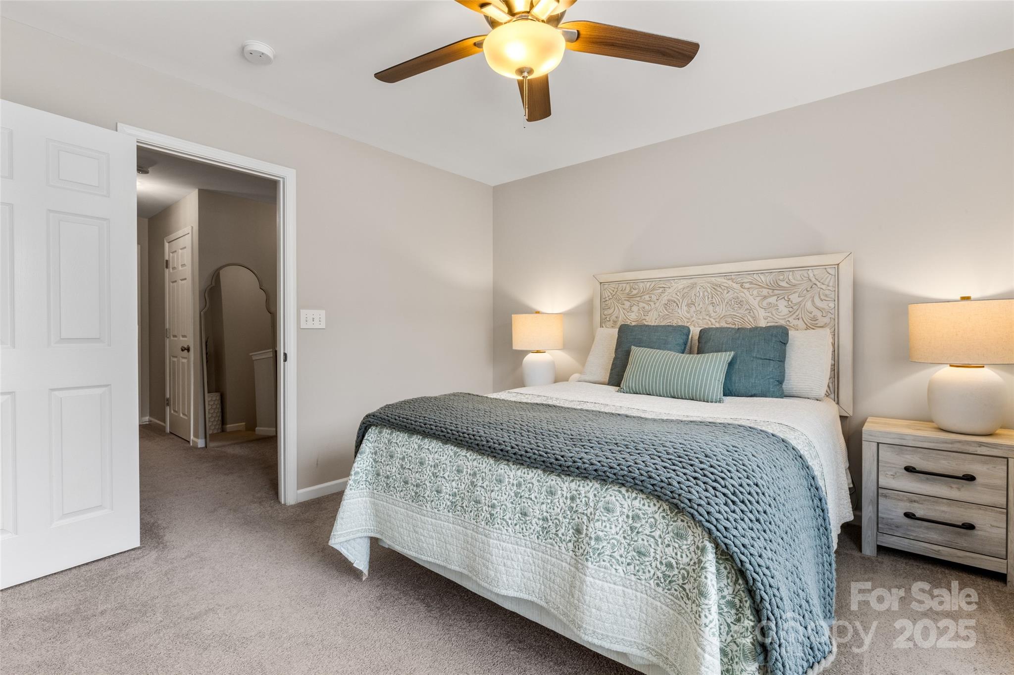 9651 Bailey Road Cornelius, NC 28031 - Photo 20 of 32 a bedroom with a bed and a chandelier