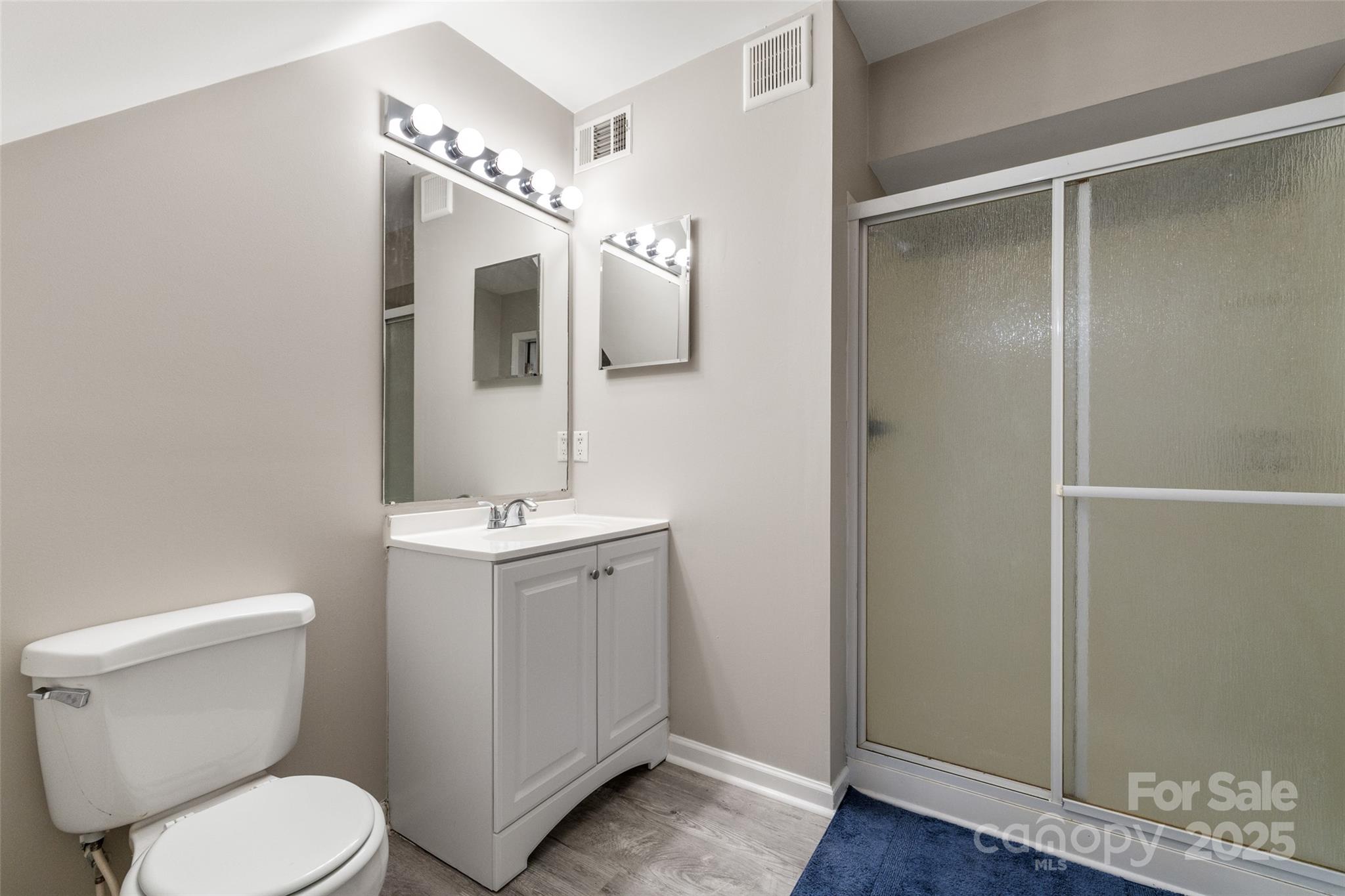 9651 Bailey Road Cornelius, NC 28031 - Photo 28 of 32 a bathroom with a toilet sink and mirror