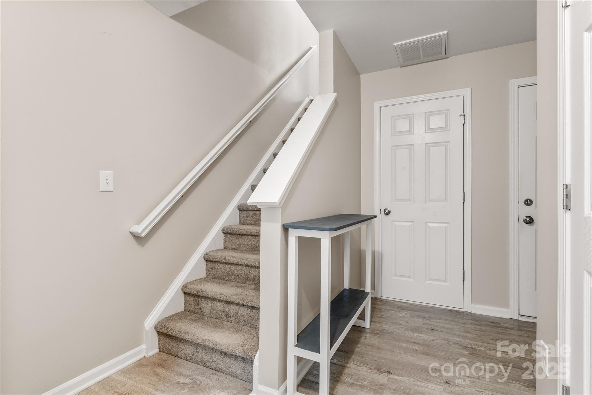 9651 Bailey Road Cornelius, NC 28031 - Photo 5 of 32 a view of entryway with wooden floor and stairs