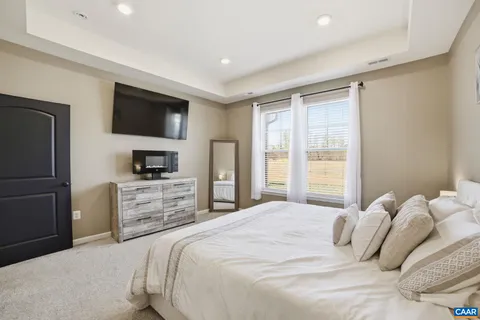 a bedroom with a bed and a television in it