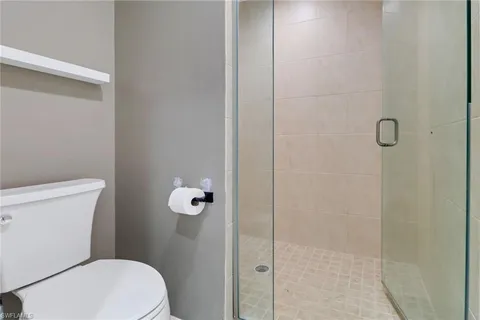 a white toilet sitting next to a bathroom