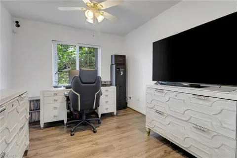 a view of workspace with wooden floor and windows
