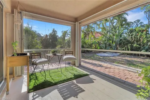 a view of a porch with chairs and backyard