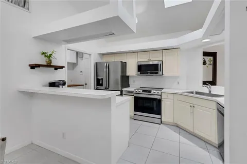 a kitchen with a sink cabinets and stainless steel appliances