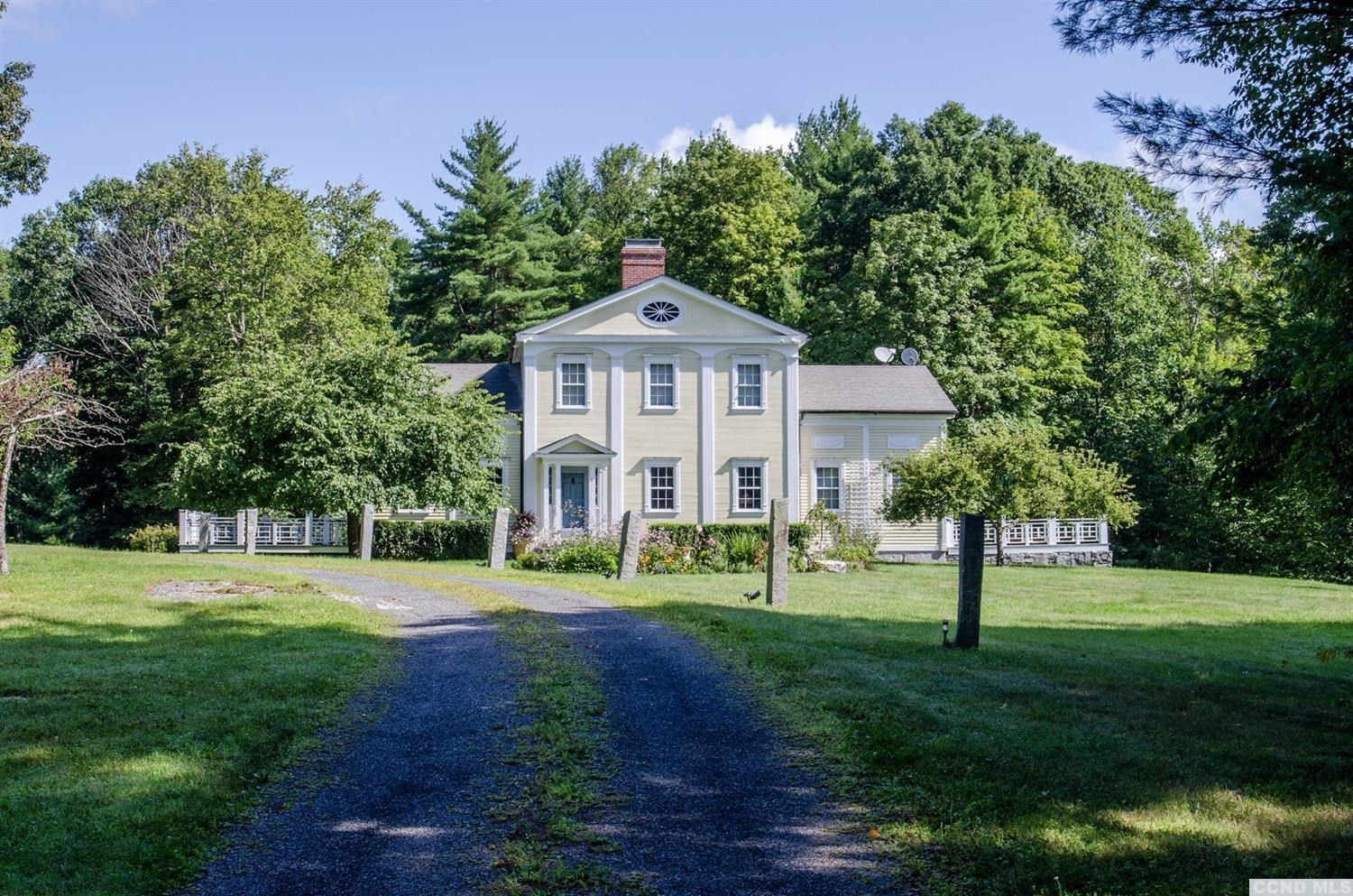 618 A Stonewall Road Austerlitz, NY 12060 - Photo 2 of 37 a front view of a house with a yard and trees