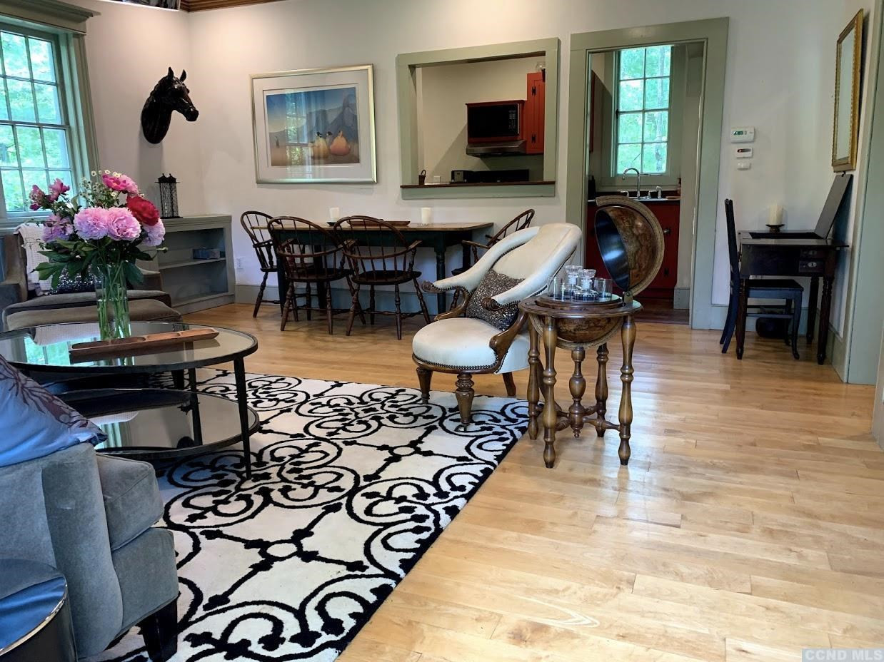 618 A Stonewall Road Austerlitz, NY 12060 - Photo 25 of 37 a living room with furniture a dining table and a potted plant