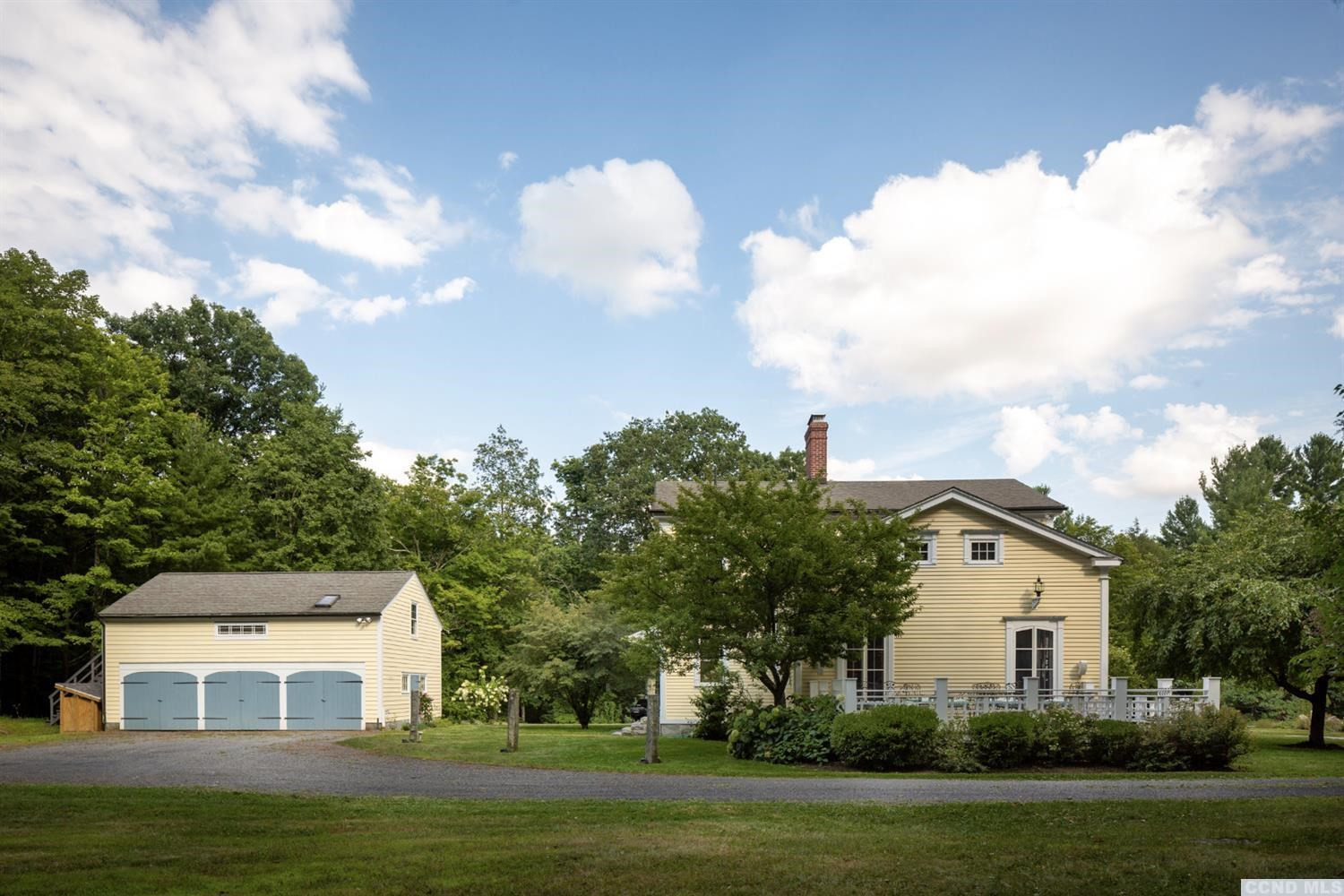618 A Stonewall Road Austerlitz, NY 12060 - Photo 6 of 37 a front view of a house with a garden and trees