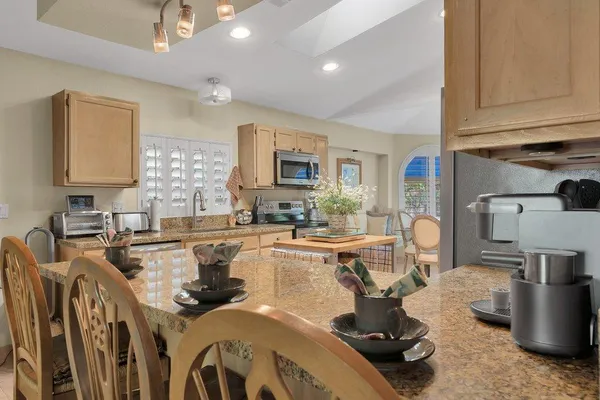 a kitchen with counter top space a sink appliances and cabinets
