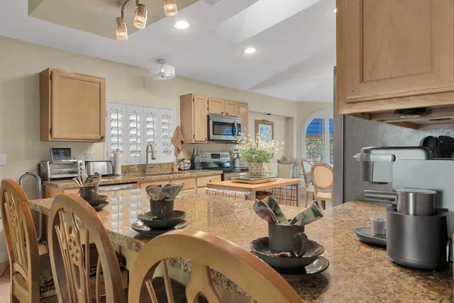 a kitchen with counter top space a sink appliances and cabinets